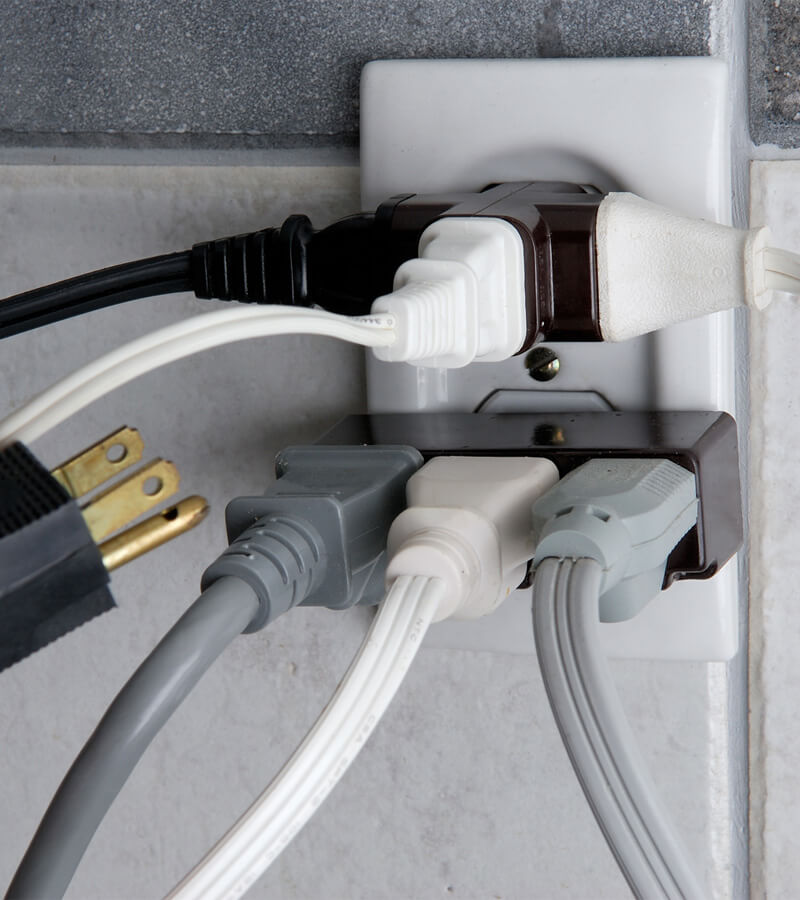 An overcrowded outlet with not enough sockets